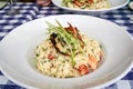 Lobster risotto in a white bowl topped with a half a grilled lobster tail Royalty Free Stock Photo