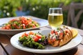 lobster roll served alongside a light salad on a patio Royalty Free Stock Photo