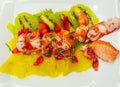 lobster salad with lobster and a bed of strawberries kiwis and pieces of pineapple
