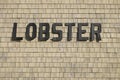 Lobster Sign On A Clapboard Commercial Structure At A New England Working Dock