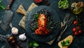 Lobster tail baked in garlic sauce and black pasta with cuttlefish ink. Luxury restaurant food. Seafood. Royalty Free Stock Photo