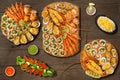 Lobster, grilled lobster , scallops, grilled oysters and mussels with cheese, grill cuttlefish, scallops in wooden plate Royalty Free Stock Photo