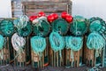 Lobster traps standing on a pier prepared for fishing with ropes and buoys Royalty Free Stock Photo