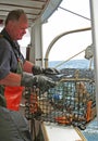 Lobsterman on boat with trap Perkins Cove Maine