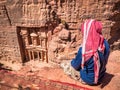 Local arab bedouin man looking at Al-Khazneh The Treasury one of the most elaborate temples in the ancient city of Petra, Jordan