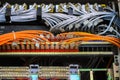 Local area network circuit box with multiple LAN RJ-45 cable relay connectors with selective focus on cables. Royalty Free Stock Photo