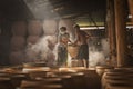 Local artisans crafting Thai-style dragon jars in factory at Ratchaburi, Thailand