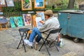 Local artist creating painting art at weekend walking street