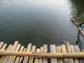 Local bamboo bridge foreground over the river Royalty Free Stock Photo