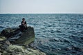 Local boy is fishing for dinner in the shore of the caspian sea where desert and water meets