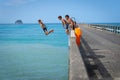 Local boys jumping of Tolaga Bay Wharf