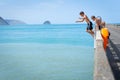 Local boys jumping of Tolaga Bay Wharf