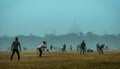 Local boys playing cricket match in a misty winter morning