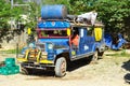 The local bus station. Loading and refueling jeepney. Royalty Free Stock Photo