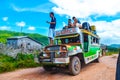 The local bus station. Loading and refueling jeepney. Royalty Free Stock Photo