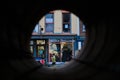 Local business and cafe view through pipeline in Troy NY.