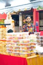 Local businessman is selling Indian assorted sweets or mithai during Deepavali