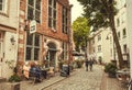 Local cafe on narrow street of historical area with some visitors in old town