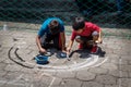 Local children making alfombra, sawdust carpets for Semana Santa, Easter on the street of Santiago Atitlan, Guatemala