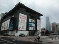 A local Chinese rode a bicycle and passed by the Silk Market shopping mall in a cloudy day, in Beijing, China