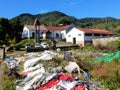 Madagascar, Local church with washed colorful clothes drying on the grass and bushes