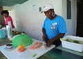 Local cook prepares traditional Bahamian conch salad in Caribbean restaurant in Harbor Island, Bahamas
