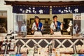 Local dessert snack shop and male sellers at shopping street at