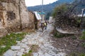 Sirince, Izmir, Turkey - 03.08.2021: an old man with donkey walking on a cobblestone street in Sirince village