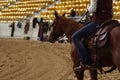 local farmers riding their quaterhorses, competing at a cutting horse, futurity event