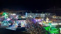 Fairground full of people in a summer night.