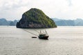 A local fisherman boat among the karst formations in Halong Bay, Vietnam, in the gulf of Tonkin