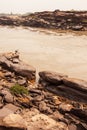 A local fisherman casting the fishing net in the Mekong River, fantastic scenery of steep by the river Royalty Free Stock Photo