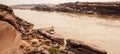 A local fisherman casting the fishing net in the Mekong River, fantastic scenery of steep by the river Royalty Free Stock Photo