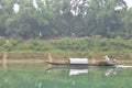 Local fisherman are fishing with his small boat on the Trang An river Royalty Free Stock Photo