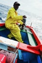 local fisherman going out to sea to fish for yellow fin tuna or wahoo in a traditional colorful dinghy