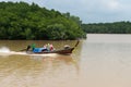 Local fisherman and his wife, cruising along the Krabi River in