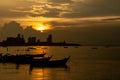 Local fisherman and small fishing boats at sunset