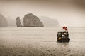 Local fisherman on a small wooden boat in Ha Long Bay. Catba, Vietnam - 03/02/2020 Royalty Free Stock Photo