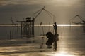 Local fisherman started his work early morning, in the golden sunrise in the wetland Talay Noi, Pattalung, Thailand. Royalty Free Stock Photo