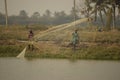 local fishermen throwing and hauling fishing net to catch fish in a pond, Henry's island, westbengal, india Royalty Free Stock Photo