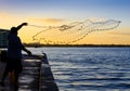 Local fisherman throws net to catch minnows.