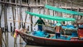 Local fishermen clean their nets on a boat at Phli Pier. Local fishing port in Chonburi Province, Thailand Royalty Free Stock Photo