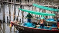 Local fishermen clean their nets on a boat at Phli Pier. Local fishing port in Chonburi Province, Thailand Royalty Free Stock Photo