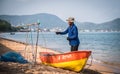 Local fishermen cleaning fishing nets on the beach of Ban Bang Saray