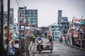 Local fishermen drive a tricycle to the local fishing port of Ban Bang Saray, eastern Thailand