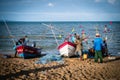 Local fishermen help unpack fish from nets at the local fishing pier, Jomtien Beach, Pattaya