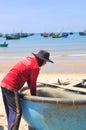 Local fishermen are preparing their fishing nets for a new working day in the Lagi beach Royalty Free Stock Photo