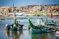 Local fishermen push traditional boat into small harbour