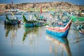 Local fishermen push traditional boat into small harbour