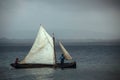 Men sail a small boat